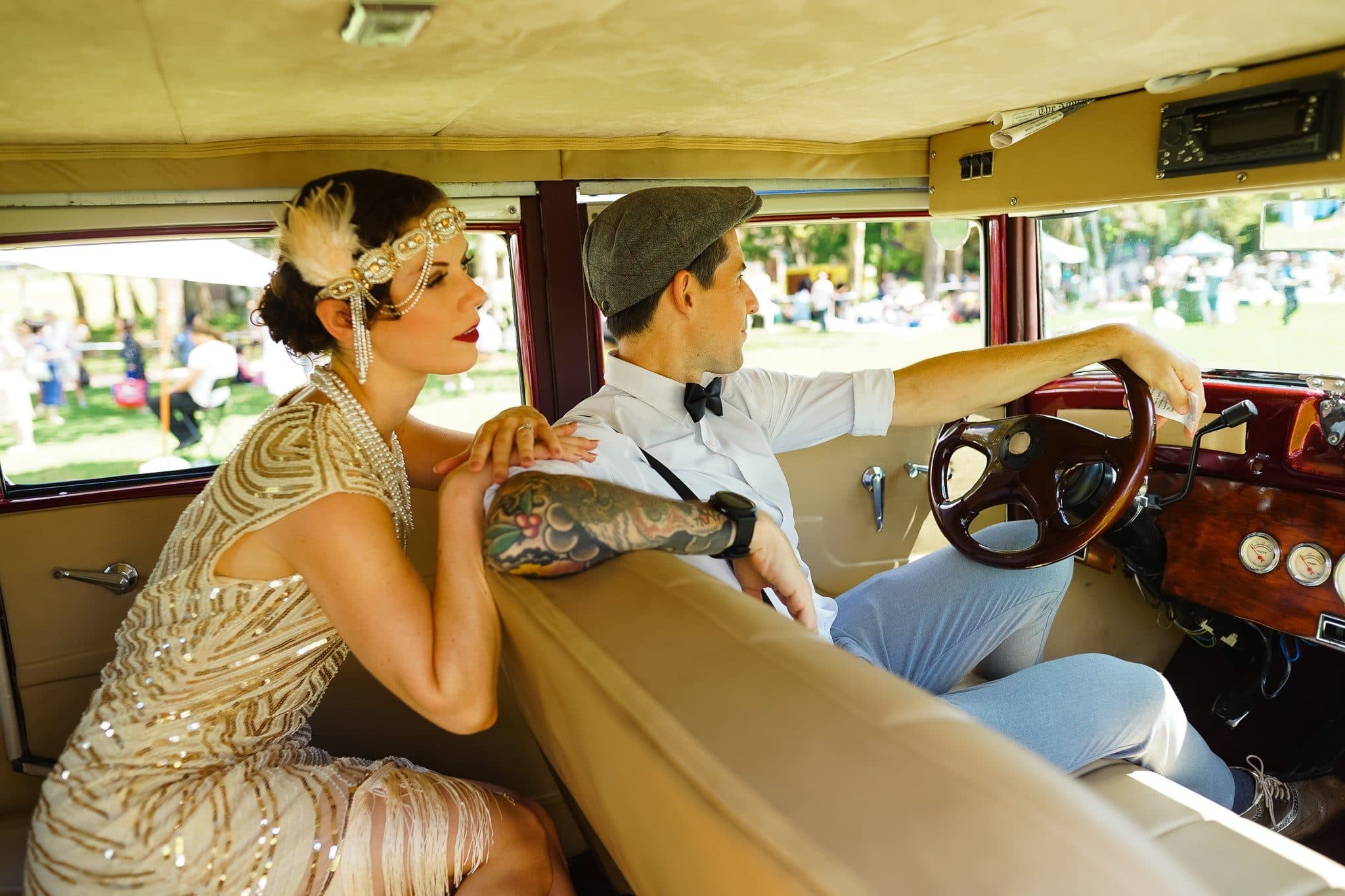 Guests in 1920s dress with a Nowaday vintage car at the Jazz Age Lawn Party