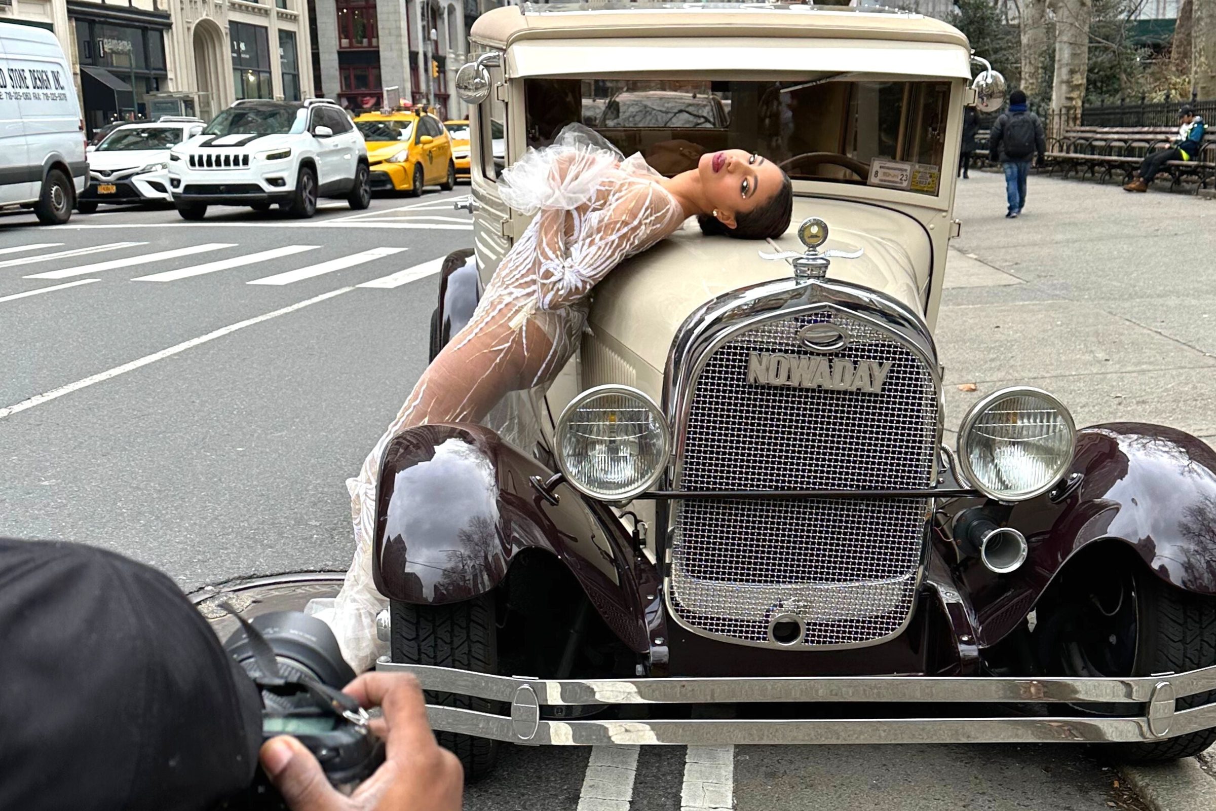 Model posing with a vintage car in Manhattan